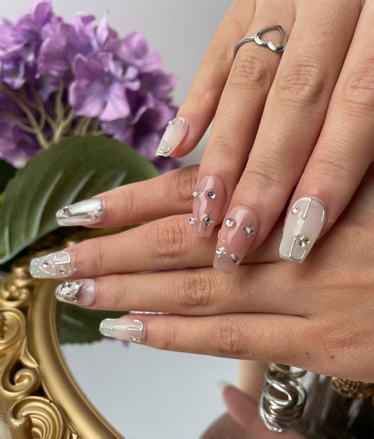 Close-up of artisanal press-on nails with 3D details and glossy finish